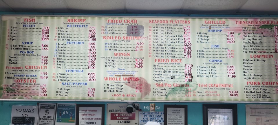 Fried shrimp and oysters on paper-lined trays.