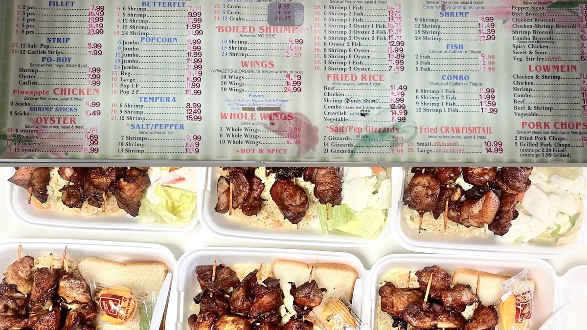 Fried shrimp and oysters on paper-lined trays.
